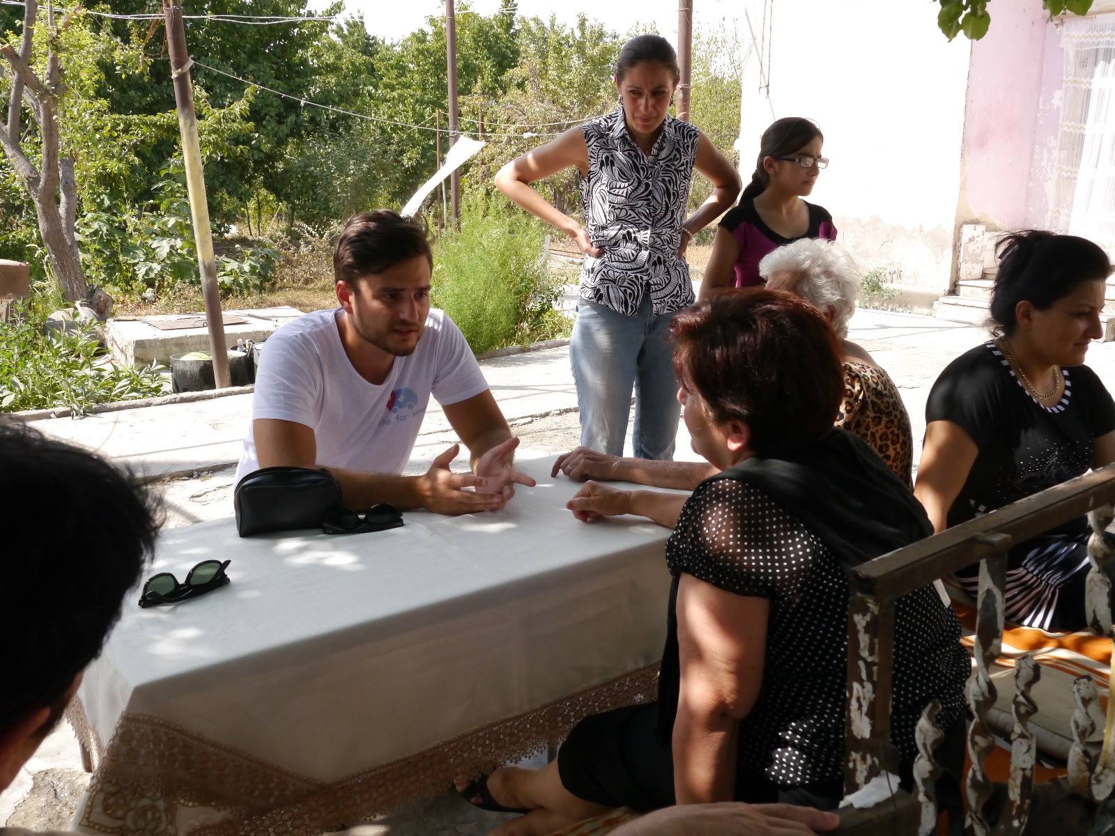 A conversation around a table during the humanitarian journey to Mongolia
