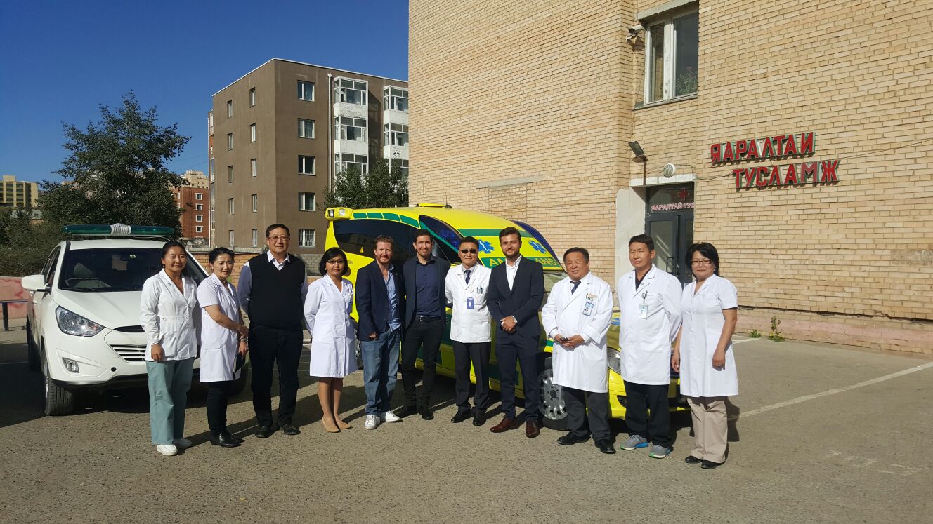 A group outside a hospital beside ambulances in Mongolia