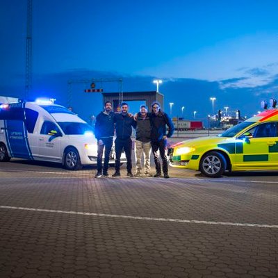 A group standing between ambulances at dusk during the work in Ukraine
